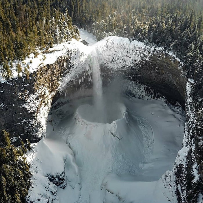 Amazing snow crater formed in plunge pool of Helmcken Falls (Canada)