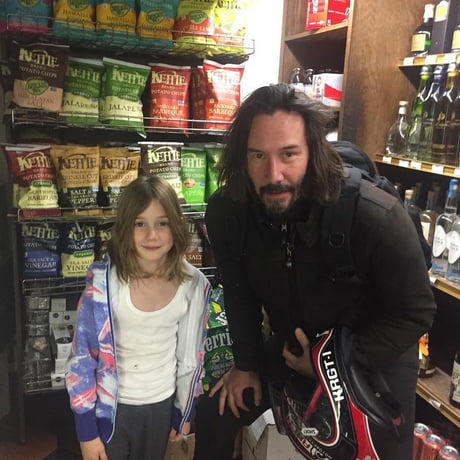 Keanu poses with a young fan.