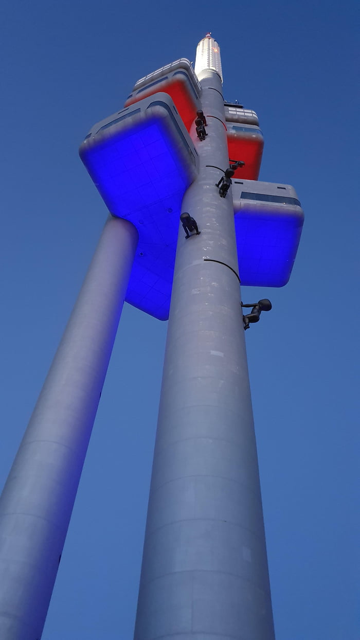 Prague TV tower with sculpture of crawling babies. Tower is 216 m high, babies 3.5 m tall. It has cool lighting.